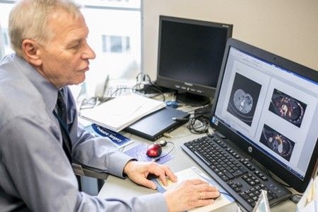 dr hab. n. med. Andrzej Igor Prokurat analizuje badania obrazowe widoczne na ekranie komputera